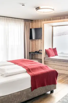 Ein Bett oder Betten in einem Zimmer der Unterkunft Hotel Astrid inklusive JokerCard & Pool