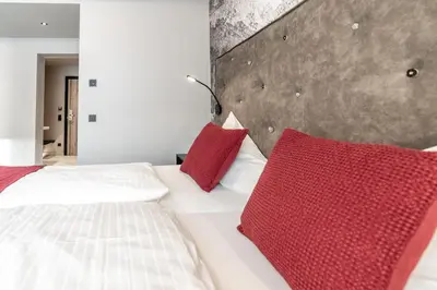 Ein Bett oder Betten in einem Zimmer der Unterkunft Hotel Astrid inklusive JokerCard & Pool
