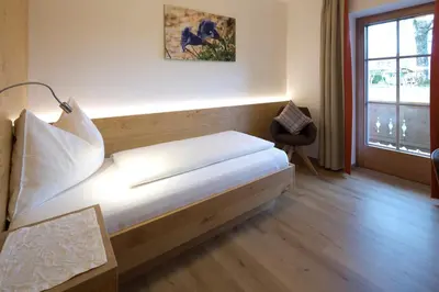 Ein Bett oder Betten in einem Zimmer der Unterkunft Gästehaus Brantlhof Zimmer und Ferienwohnungen in Going am Wilden Kaiser
