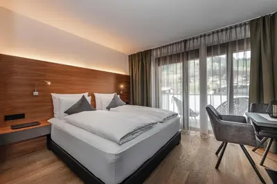 Ein Bett oder Betten in einem Zimmer der Unterkunft AlpenParks Hotel & Apartment Taxacher