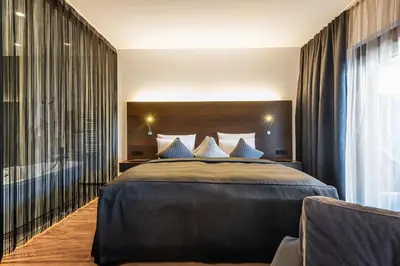 Ein Bett oder Betten in einem Zimmer der Unterkunft AlpenParks Hotel & Apartment Taxacher