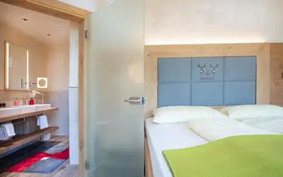 Ein Bett oder Betten in einem Zimmer der Unterkunft Seehotel St Hubertus