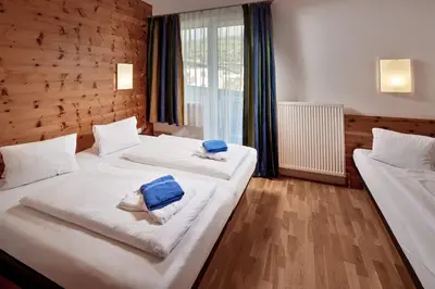 Ein Bett oder Betten in einem Zimmer der Unterkunft Sporthotel Kogler