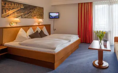 Ein Bett oder Betten in einem Zimmer der Unterkunft Vital & Sporthotel Brixen