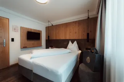Ein Bett oder Betten in einem Zimmer der Unterkunft Hotel Tannenberg