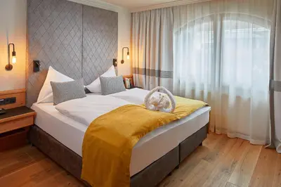 Ein Bett oder Betten in einem Zimmer der Unterkunft Sporthotel Ellmau in Tirol