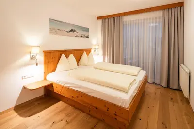 Ein Bett oder Betten in einem Zimmer der Unterkunft Apparthotel AlpenChalet