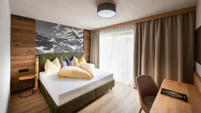 Ein Bett oder Betten in einem Zimmer der Unterkunft Hotel Königsleiten Vital Alpin
