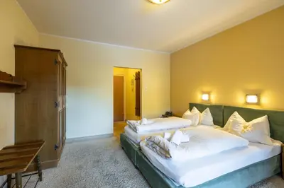 Ein Bett oder Betten in einem Zimmer der Unterkunft Hotel Austria Wildschönau