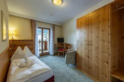 Ein Bett oder Betten in einem Zimmer der Unterkunft Hotel Austria Wildschönau