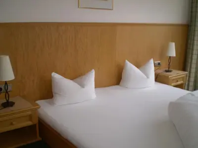 Ein Bett oder Betten in einem Zimmer der Unterkunft Apart Hotel Garni Strasser
