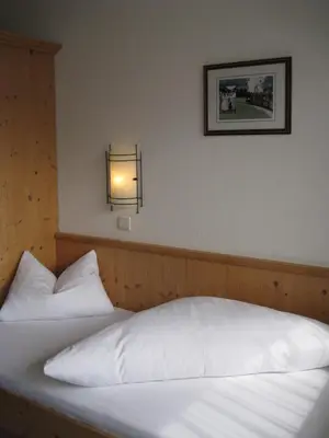 Ein Bett oder Betten in einem Zimmer der Unterkunft Apart Hotel Garni Strasser