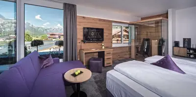 Ein Bett oder Betten in einem Zimmer der Unterkunft Arthur's Hotel und Apartments am Achensee