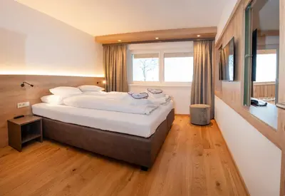 Ein Bett oder Betten in einem Zimmer der Unterkunft Hotel Der Wastlhof - direkt an der Skipiste Wellness & Spa