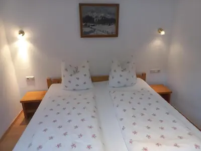 Ein Bett oder Betten in einem Zimmer der Unterkunft Scheffauerhof