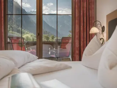 Ein Bett oder Betten in einem Zimmer der Unterkunft Hotel Garni Larcherhof