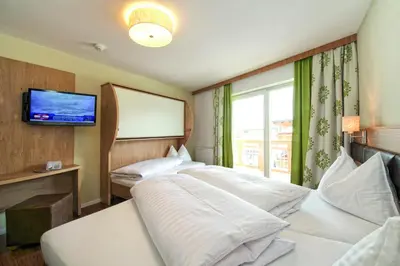 Ein Bett oder Betten in einem Zimmer der Unterkunft Hotel ALPINA
