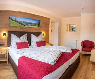Ein Bett oder Betten in einem Zimmer der Unterkunft Hotel Schneeberger