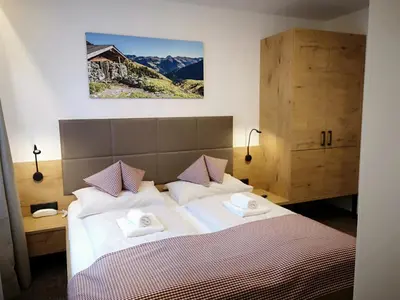 Ein Bett oder Betten in einem Zimmer der Unterkunft Hotel Aschauer Hof z'Fritzn