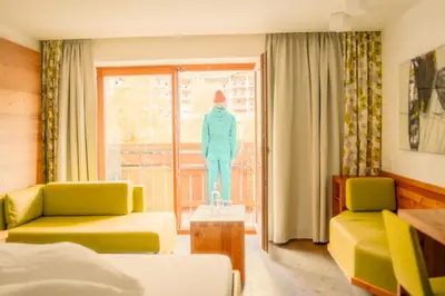 Ein Bett oder Betten in einem Zimmer der Unterkunft Hotel Glemmtalerhof