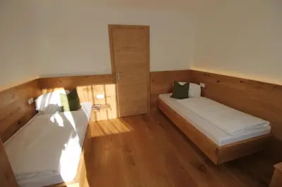 Ein Bett oder Betten in einem Zimmer der Unterkunft Ticklhof am See
