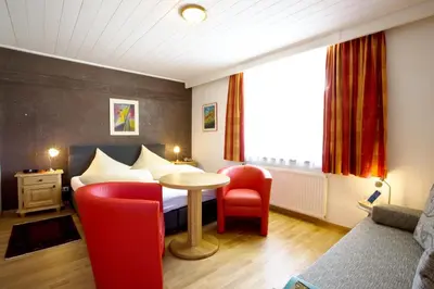 Ein Bett oder Betten in einem Zimmer der Unterkunft Noichl’s Hotel Garni
