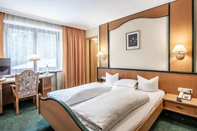 Ein Bett oder Betten in einem Zimmer der Unterkunft Naturhotel Alpenblick