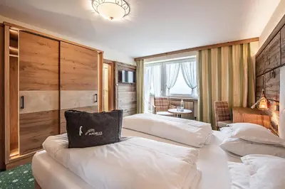 Ein Bett oder Betten in einem Zimmer der Unterkunft Naturhotel Alpenblick