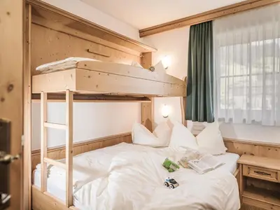 Ein Bett oder Betten in einem Zimmer der Unterkunft Kinderbauernhof Scharrerhof