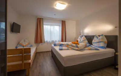 Ein Bett oder Betten in einem Zimmer der Unterkunft Ferienwohnung Lederer
