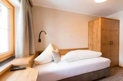 Ein Bett oder Betten in einem Zimmer der Unterkunft Der Berghof