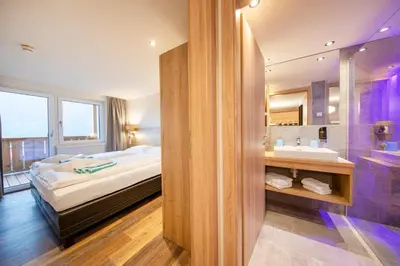 Ein Bett oder Betten in einem Zimmer der Unterkunft Hotel Post Krimml
