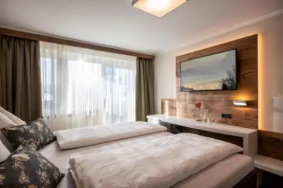 Ein Bett oder Betten in einem Zimmer der Unterkunft Hotel Baumgarten & Chalet Baumgarten