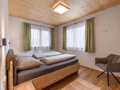Ein Bett oder Betten in einem Zimmer der Unterkunft Hotel Baumgarten & Chalet Baumgarten