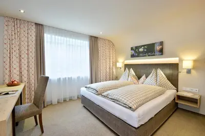 Ein Bett oder Betten in einem Zimmer der Unterkunft Hotel Hubertus