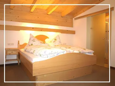 Ein Bett oder Betten in einem Zimmer der Unterkunft Kaiserapart Steinadler - ELLMAU Zentrum