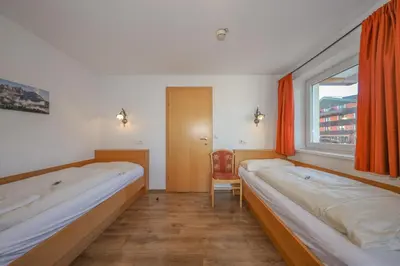 Ein Bett oder Betten in einem Zimmer der Unterkunft Appartementhaus Chalet Alpina
