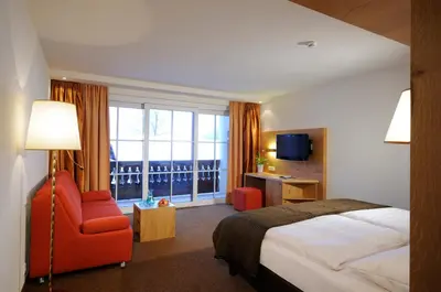 Ein Bett oder Betten in einem Zimmer der Unterkunft Hotel Saalbacher Hof