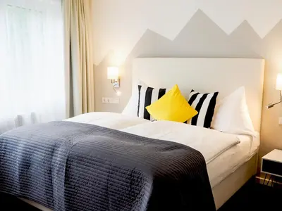 Ein Bett oder Betten in einem Zimmer der Unterkunft Hotel Saalbacher Hof