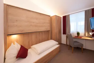 Ein Bett oder Betten in einem Zimmer der Unterkunft Appartements Alpin