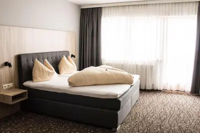 Ein Bett oder Betten in einem Zimmer der Unterkunft Panorama Lodge Hochfügen