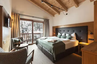 Ein Bett oder Betten in einem Zimmer der Unterkunft Das Glemm Hotel - Joker Card Partner