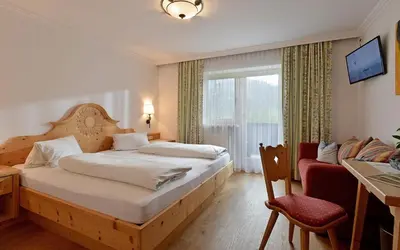 Ein Bett oder Betten in einem Zimmer der Unterkunft Pension Sunnbichl