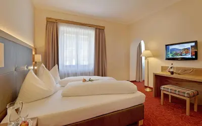 Ein Bett oder Betten in einem Zimmer der Unterkunft Hotel Andreas Hofer