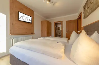 Ein Bett oder Betten in einem Zimmer der Unterkunft Residence Alpin