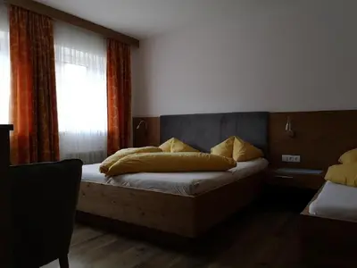 Ein Bett oder Betten in einem Zimmer der Unterkunft Gästehaus Braunegger