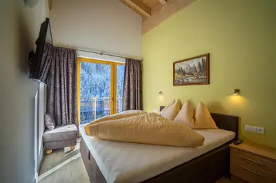 Ein Bett oder Betten in einem Zimmer der Unterkunft Alpenhof Chalets