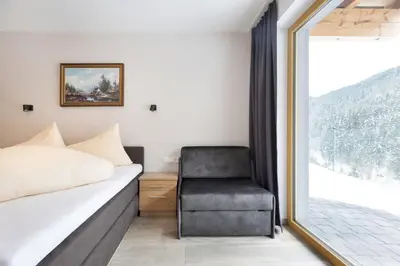 Ein Bett oder Betten in einem Zimmer der Unterkunft Alpenhof Chalets