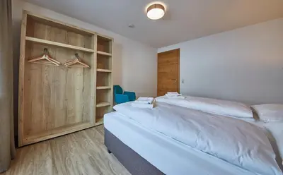 Ein Bett oder Betten in einem Zimmer der Unterkunft Glemm Lodge Apartments - JOKER CARD im Sommer inklusive