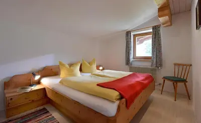 Ein Bett oder Betten in einem Zimmer der Unterkunft APARTMENTS Pension Foidl